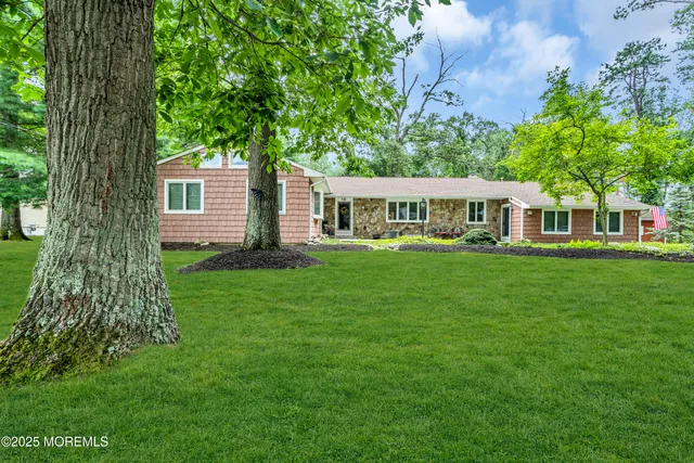 a view of a house with a backyard