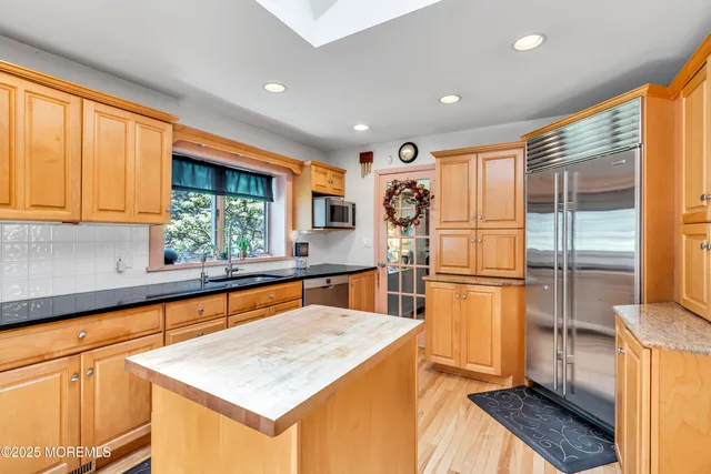 a kitchen with refrigerator and window