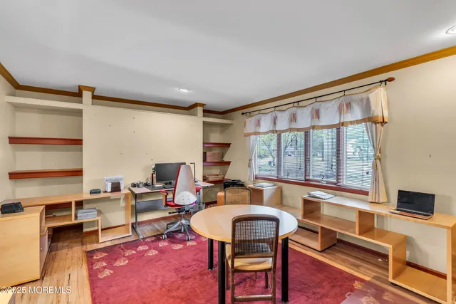 a living room with furniture a flat screen tv and a window