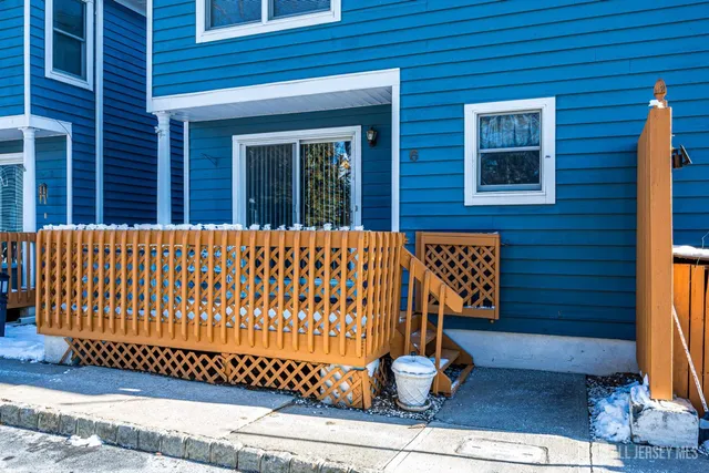 a view of wooden door with a bench