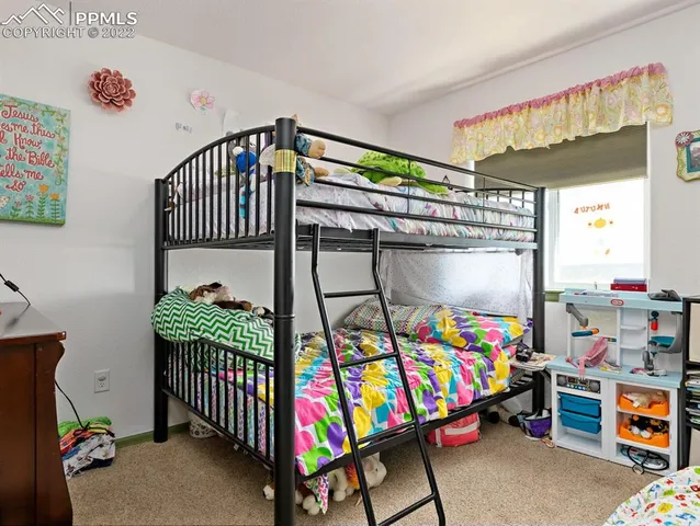 a bedroom with baby crib and a bed