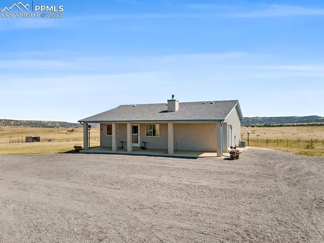 a view of a house with an outdoor space and seating area