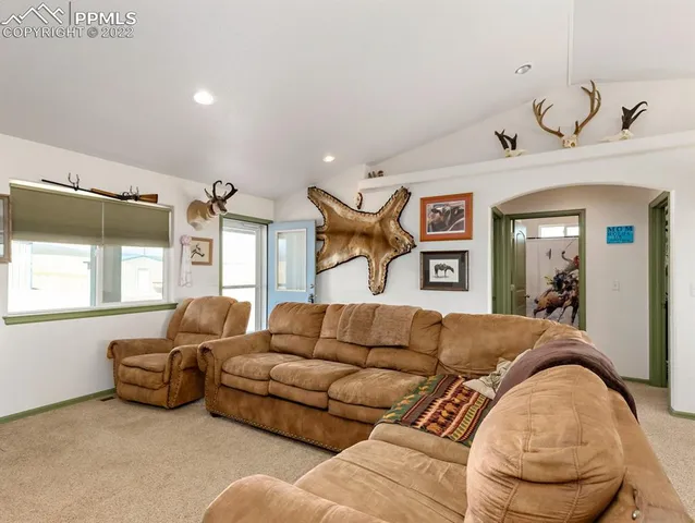 a living room with furniture chess board and a window