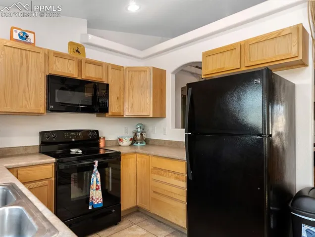 a kitchen with a refrigerator a stove and a microwave