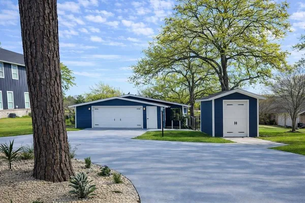 a white house that has a tree in front of it
