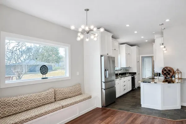 a kitchen with stainless steel appliances kitchen island granite countertop a stove a sink and a refrigerator