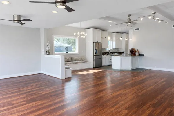 a view of a kitchen with a sink stainless steel appliances and cabinets