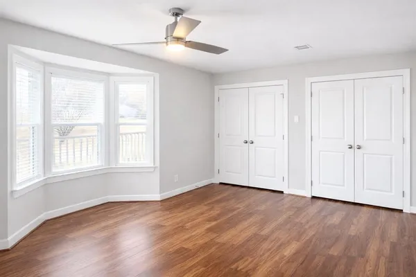 wooden floor in an empty room with a window