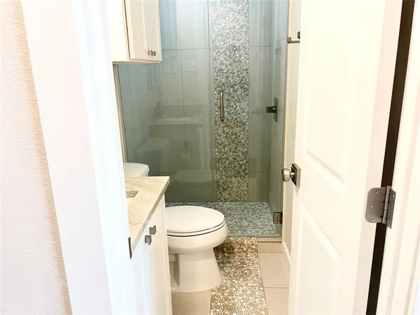a bathroom with a toilet and a shower