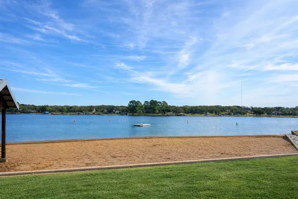 a view of a lake with houses in the back