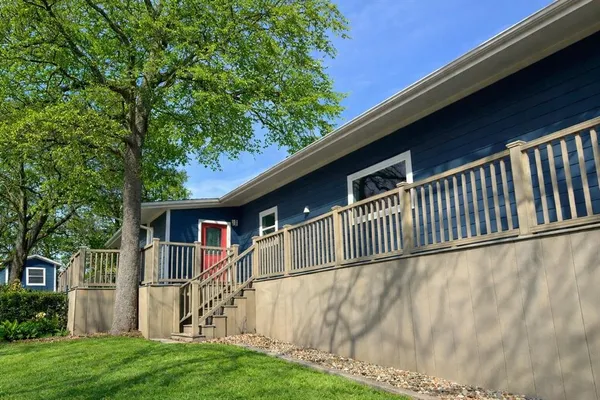 a view of house with yard and staircase