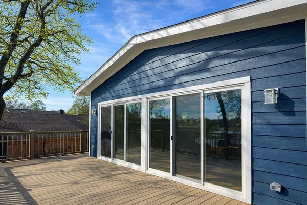 a view of backyard with large window and wooden floor