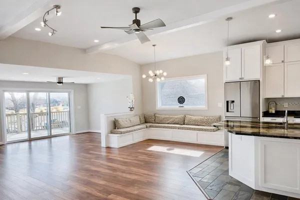 a large kitchen with kitchen island a white counter space a sink appliances and cabinets