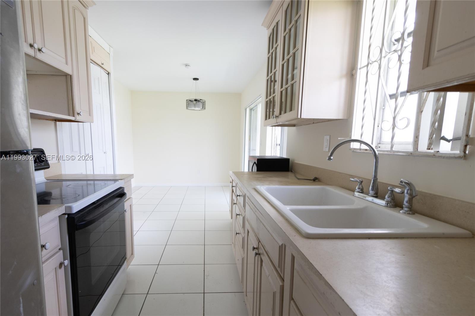 11770 Southwest 168th Street, Unit 11770 Miami, FL 33177 - Photo 13 of 22 a kitchen with a sink cabinets and a window