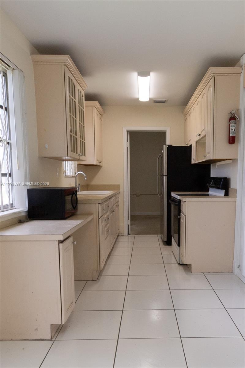 11770 Southwest 168th Street, Unit 11770 Miami, FL 33177 - Photo 17 of 22 a kitchen that has a sink and a stove in it