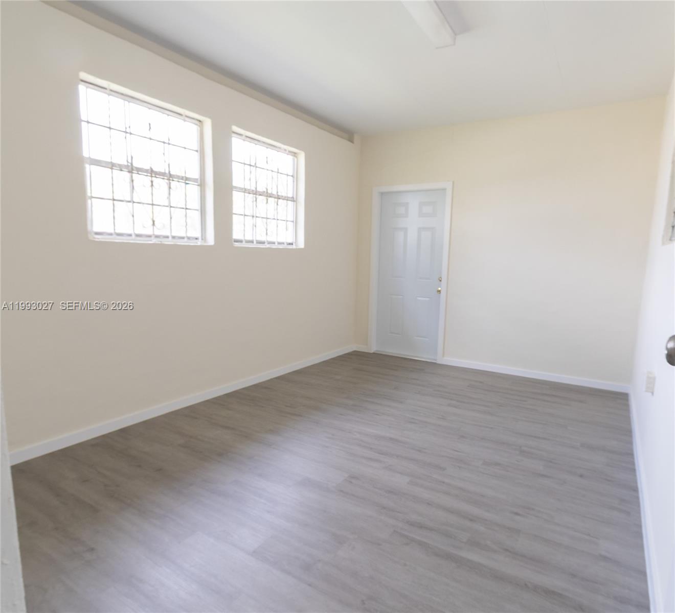 11770 Southwest 168th Street, Unit 11770 Miami, FL 33177 - Photo 19 of 22 an empty room with wooden floor and windows