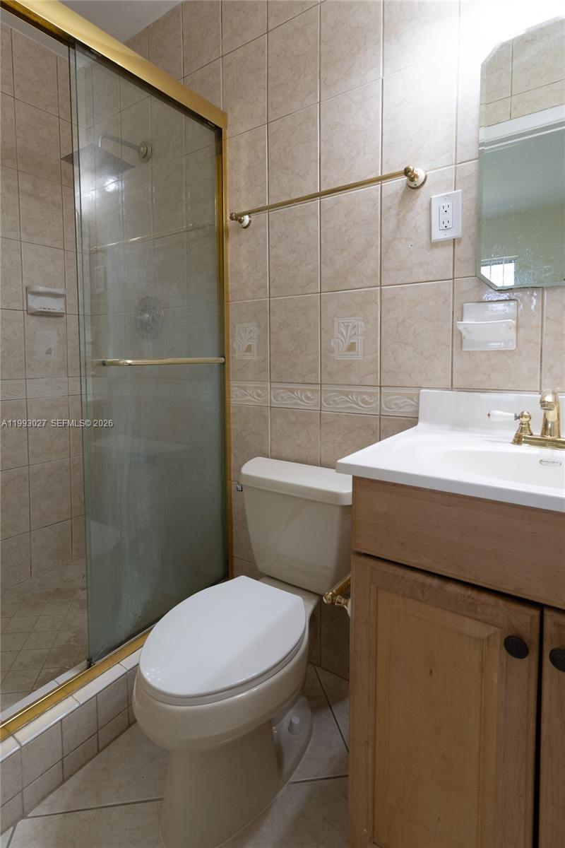 11770 Southwest 168th Street, Unit 11770 Miami, FL 33177 - Photo 10 of 22 a bathroom with a sink a toilet and shower