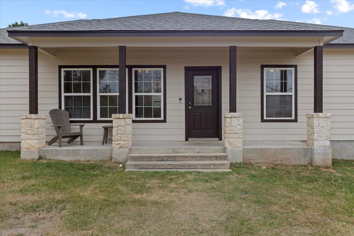 a front view of a house with garden