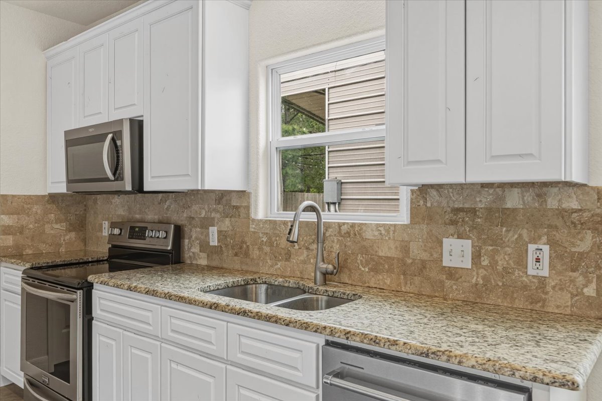 207 Cardinal Loop Paige, TX 78659 - Photo 11 of 39 a kitchen with sink and window