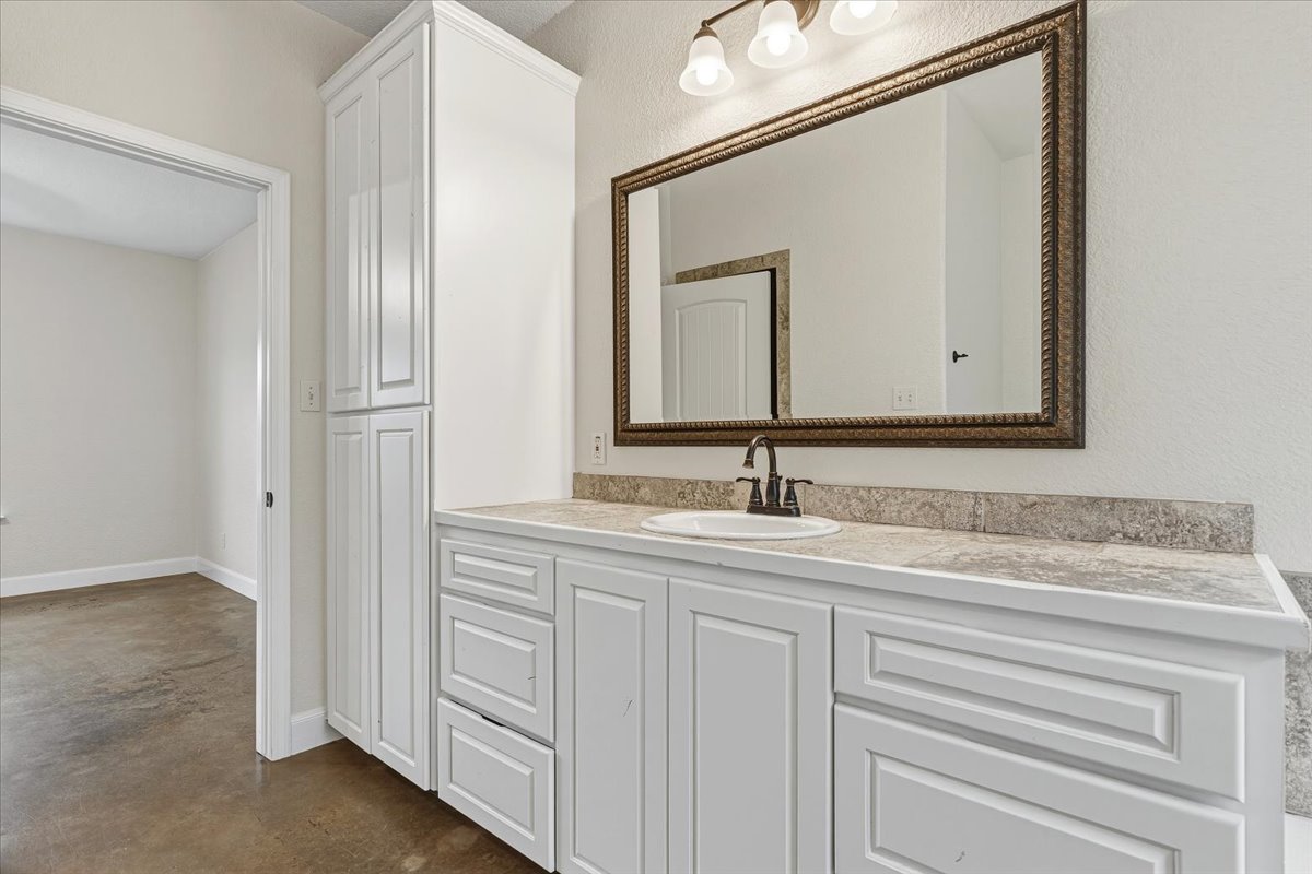 207 Cardinal Loop Paige, TX 78659 - Photo 17 of 39 a bathroom with a sink and a mirror