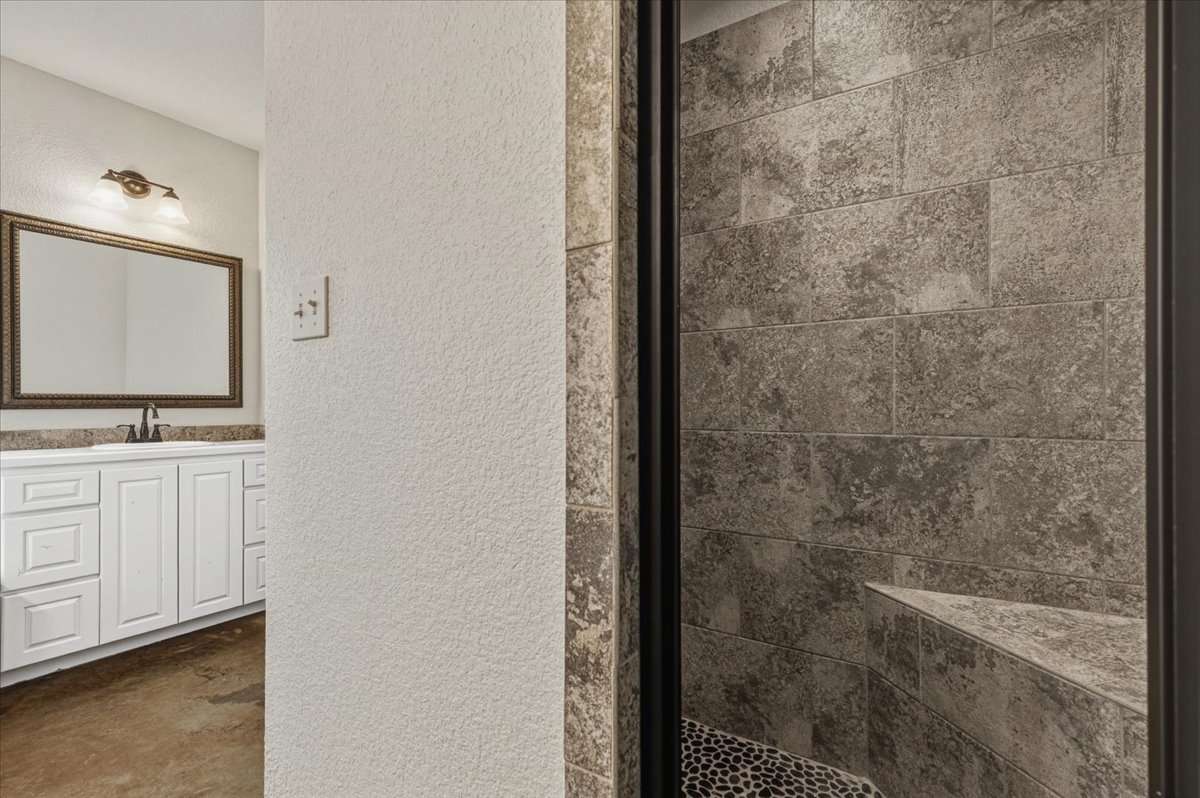207 Cardinal Loop Paige, TX 78659 - Photo 19 of 39 a bathroom with a shower and a sink