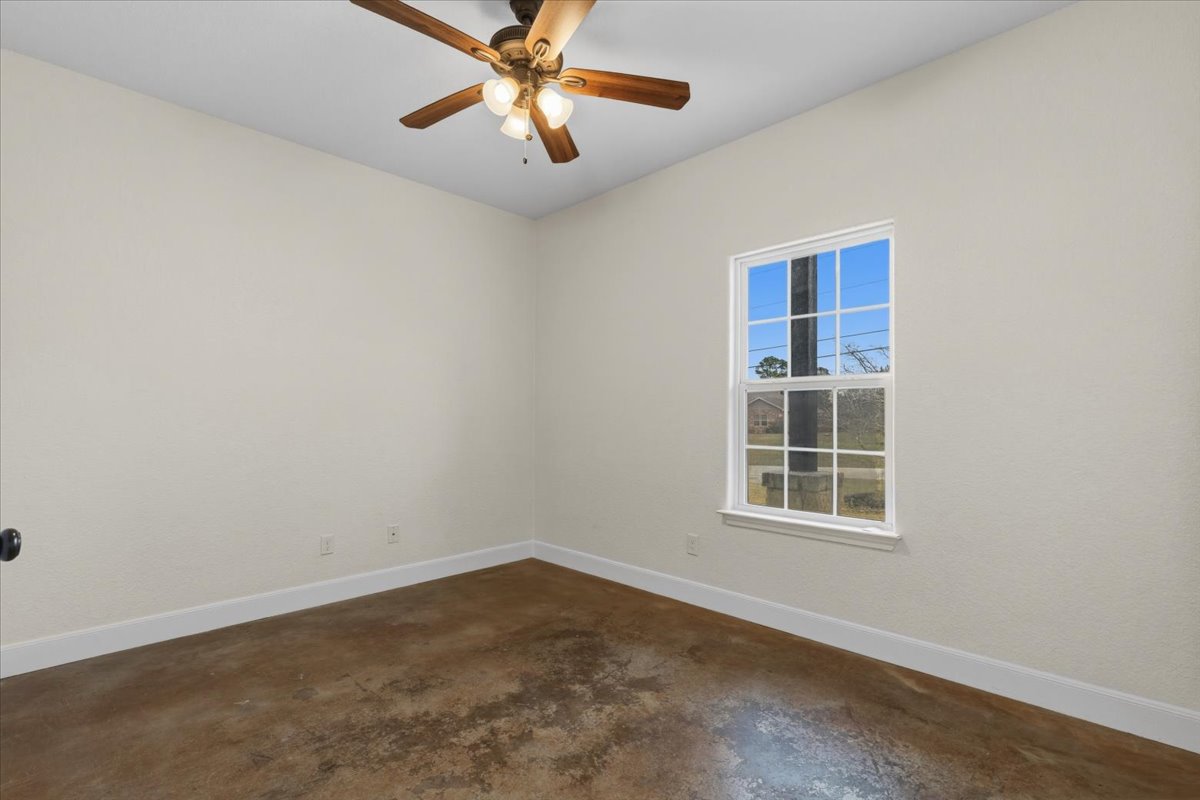 207 Cardinal Loop Paige, TX 78659 - Photo 21 of 39 an empty room with a window and a fan
