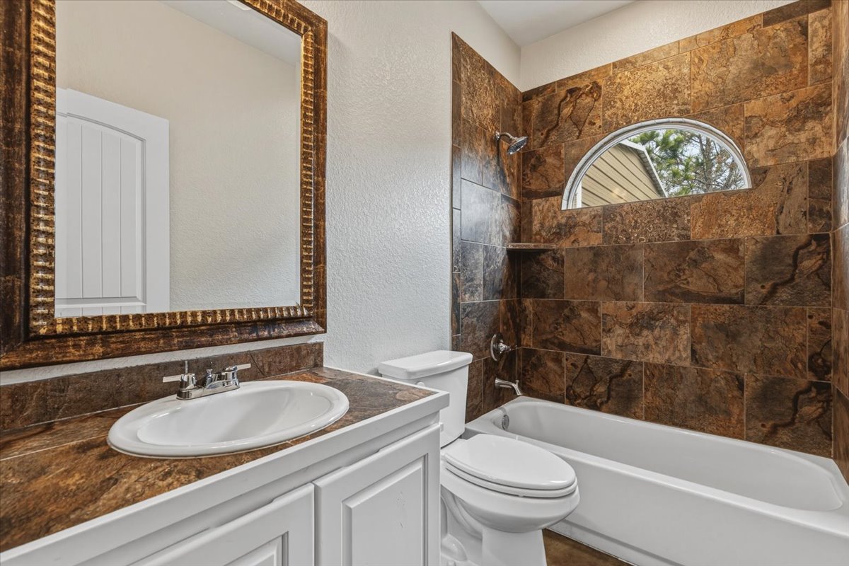 207 Cardinal Loop Paige, TX 78659 - Photo 23 of 39 a bathroom with a sink and a mirror