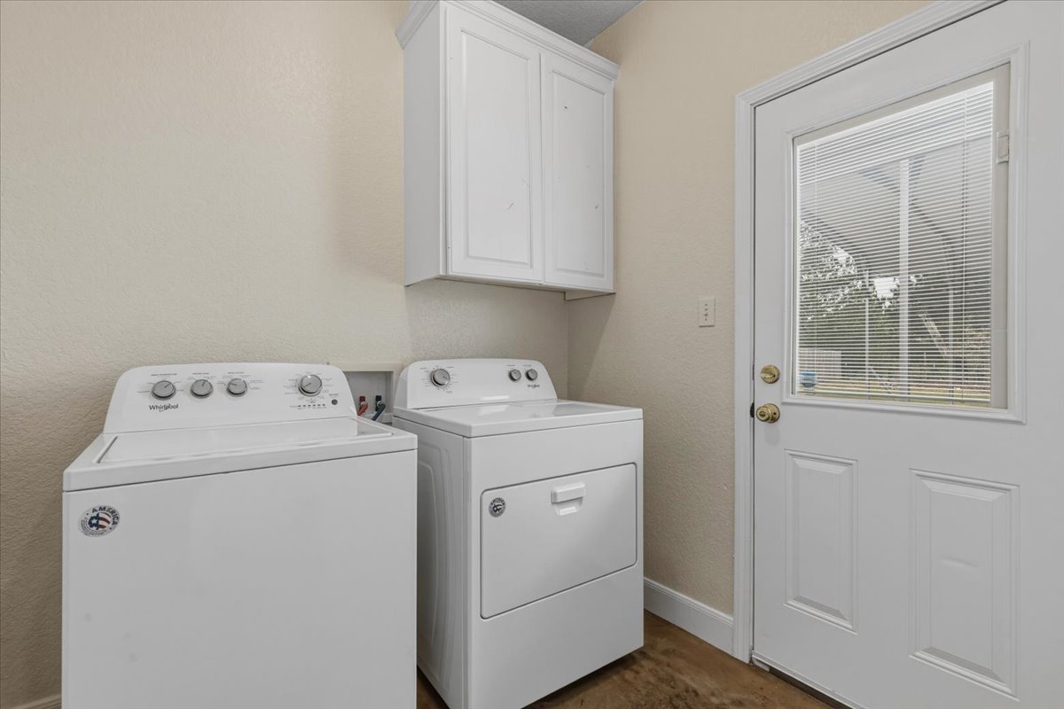 207 Cardinal Loop Paige, TX 78659 - Photo 28 of 39 a utility room with dryer and washer