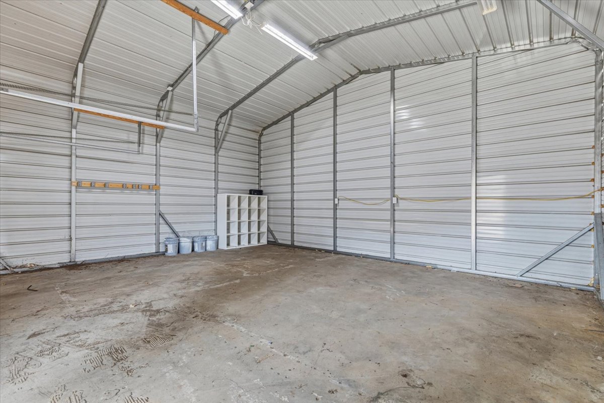207 Cardinal Loop Paige, TX 78659 - Photo 38 of 39 Garage featuring metal wall