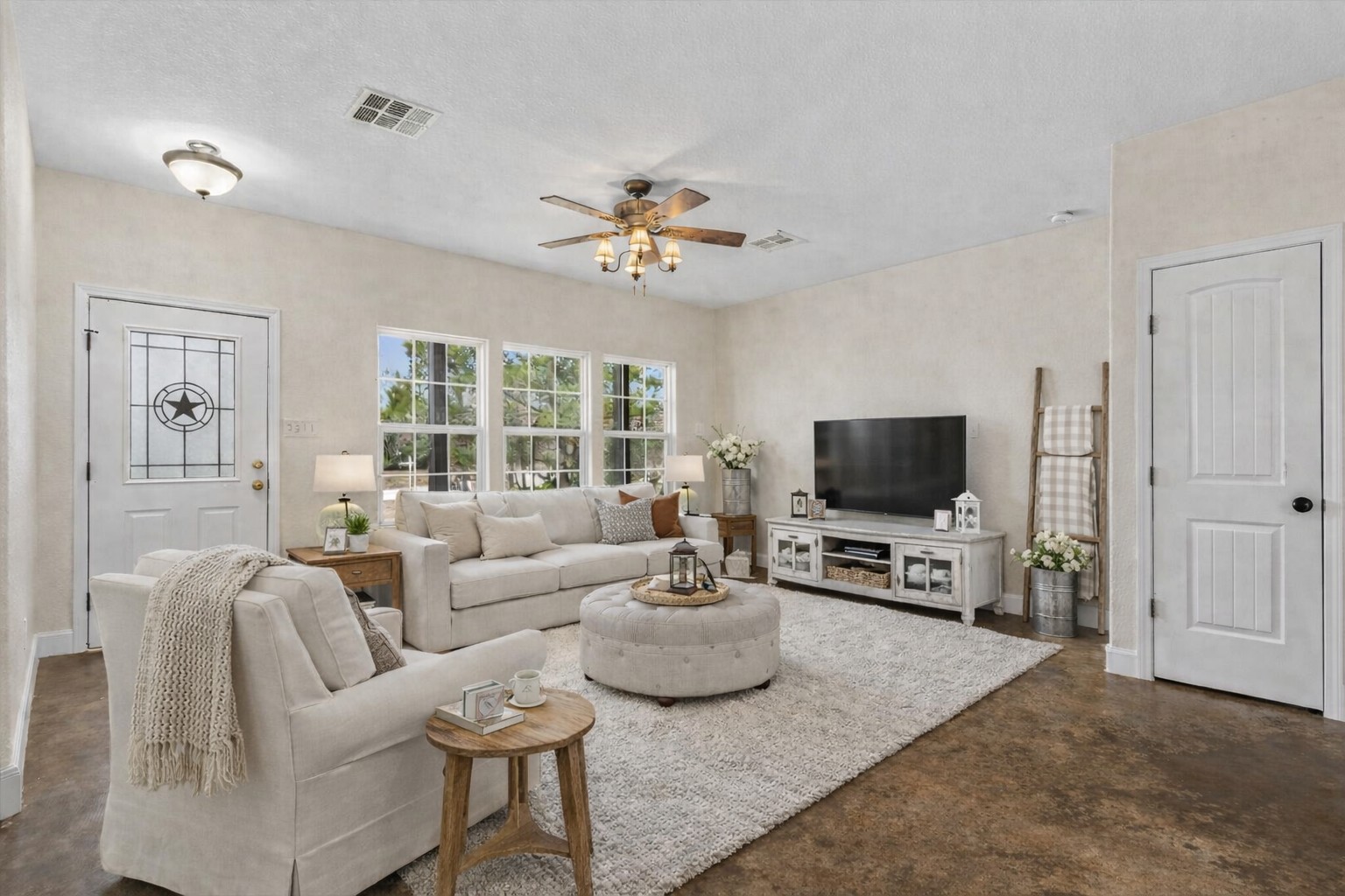 207 Cardinal Loop Paige, TX 78659 - Photo 5 of 39 a living room with furniture a flat screen tv and a large window
