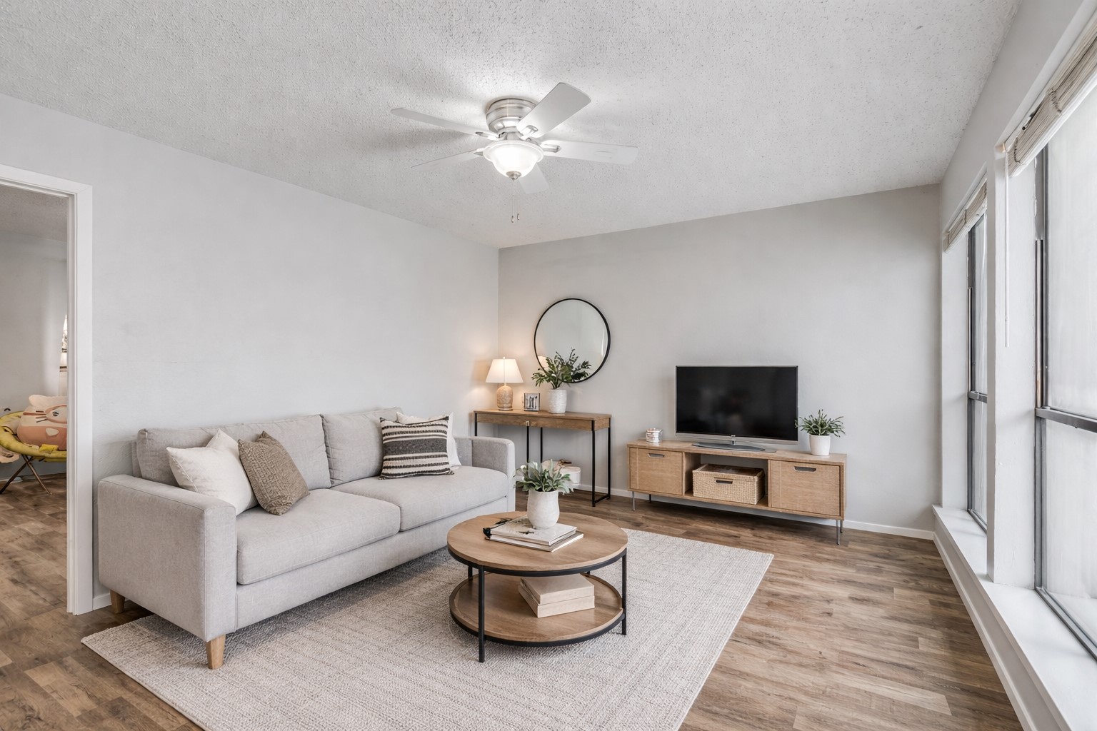 3115 Helms Street, Unit 210 Austin, TX 78705 - Photo 2 of 17 a living room with furniture a window and a flat screen tv