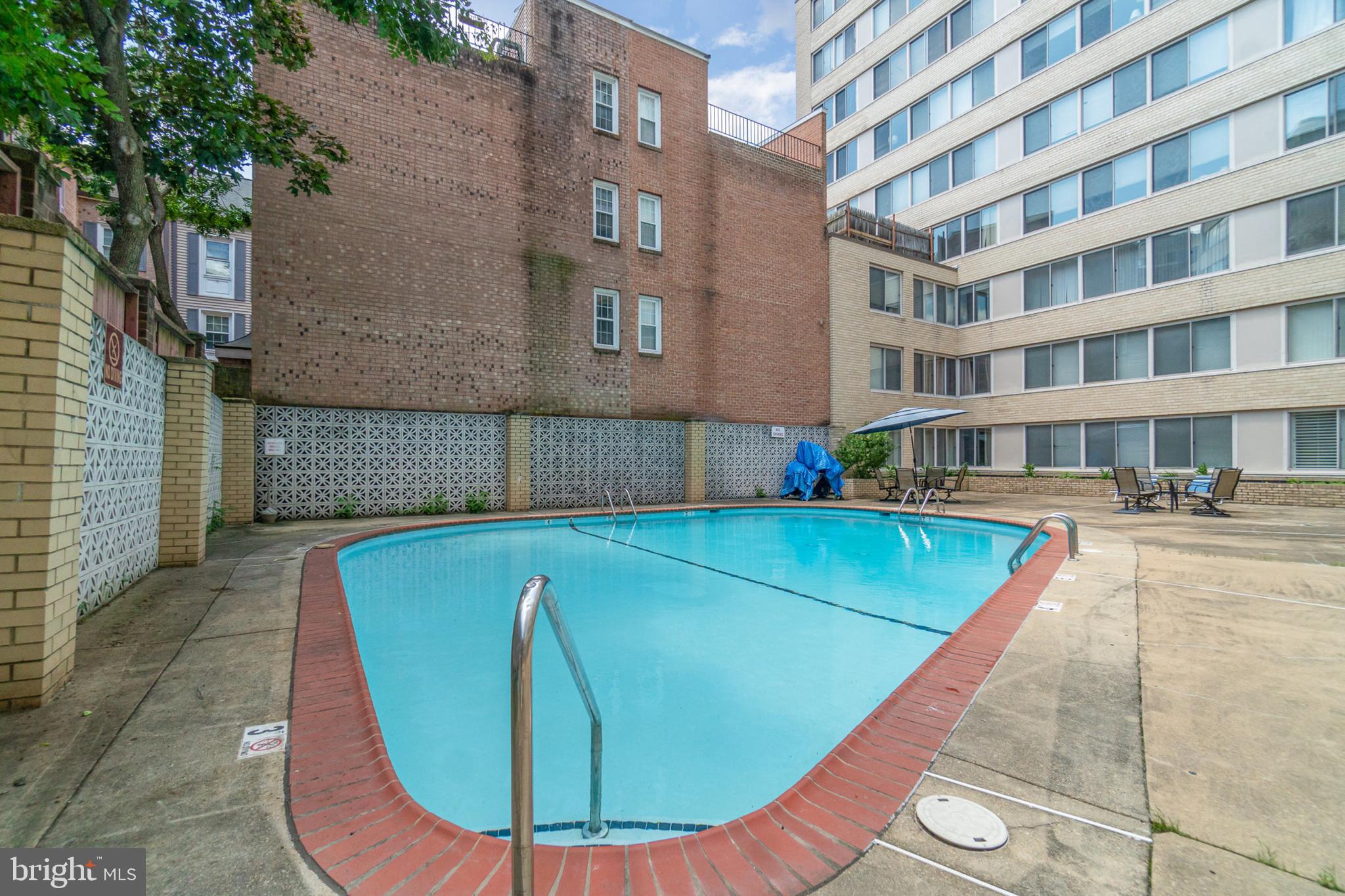 922 24th Street Northwest, Unit 313 Washington, DC 20037 - Photo 18 of 22 a view of a swimming pool with a lounge chairs