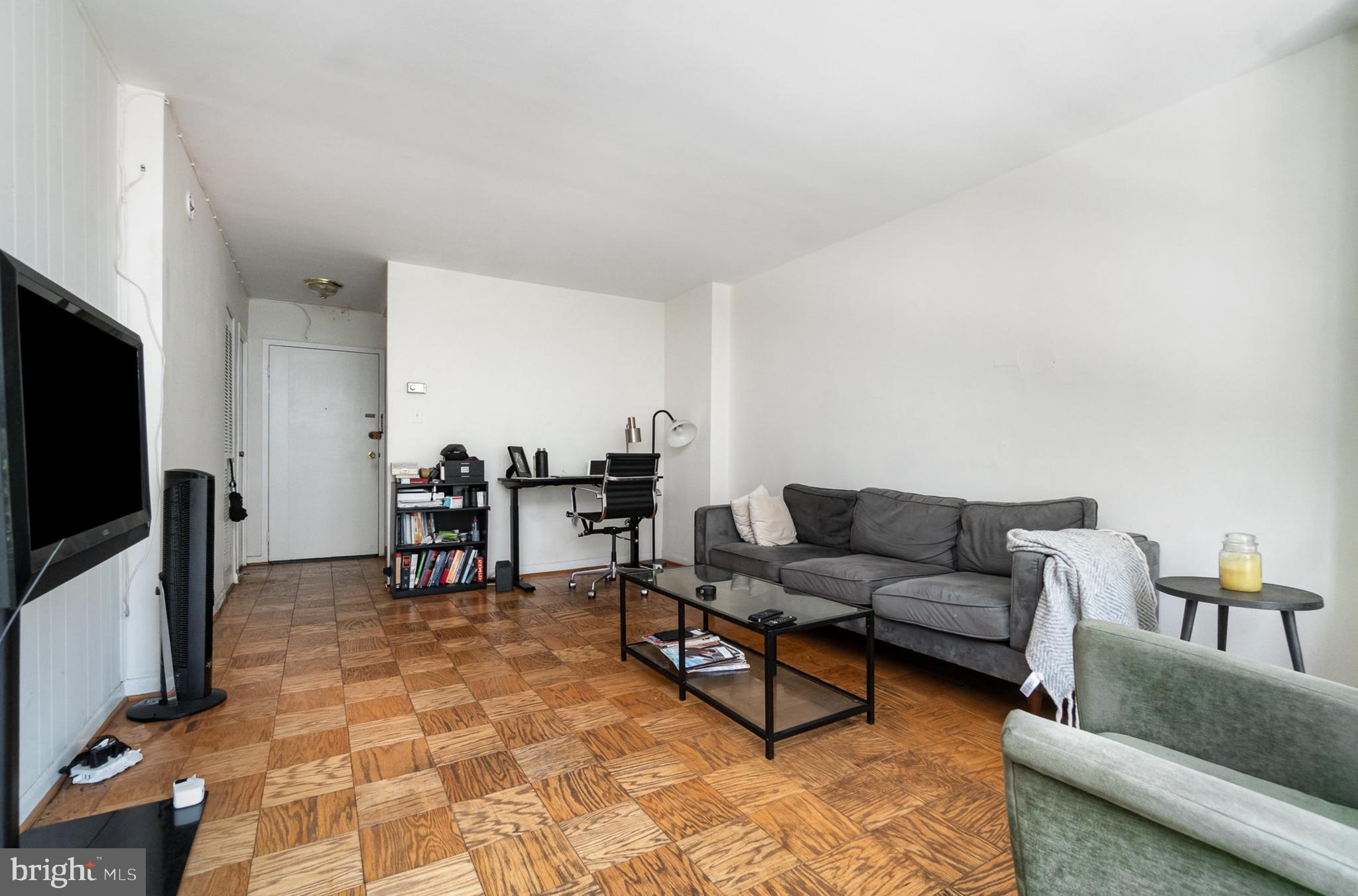 922 24th Street Northwest, Unit 313 Washington, DC 20037 - Photo 6 of 22 a living room with furniture and a flat screen tv