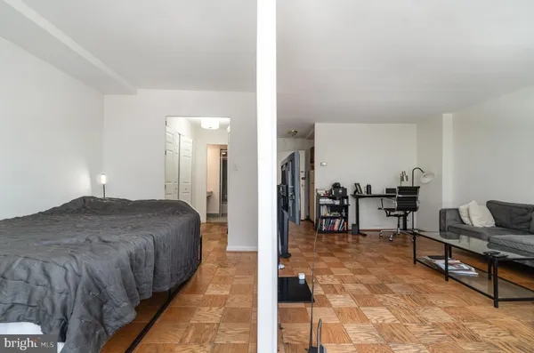 a bedroom with a bed and dresser