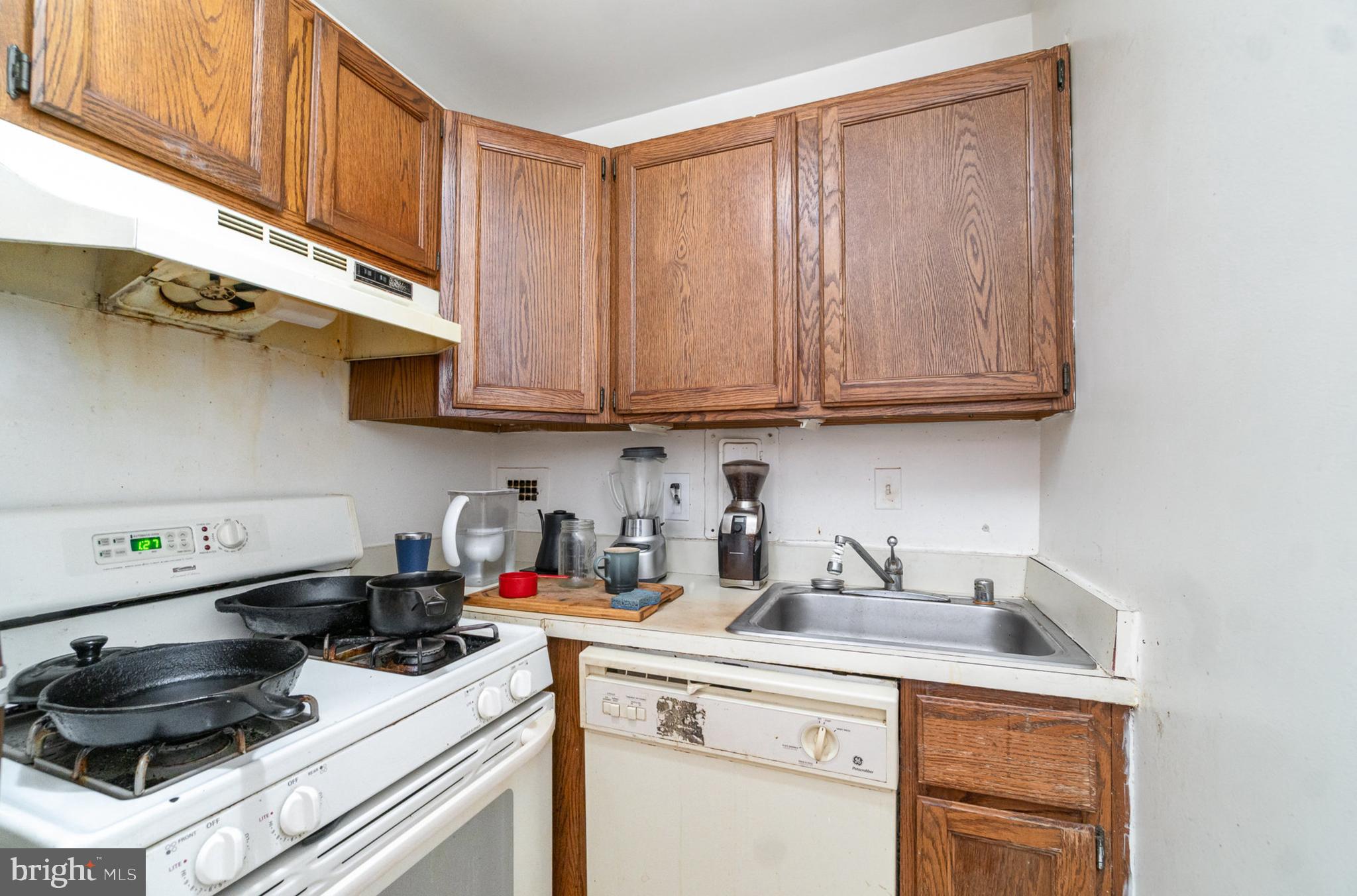 922 24th Street Northwest, Unit 313 Washington, DC 20037 - Photo 9 of 22 a kitchen with stainless steel appliances granite countertop a sink a stove and cabinets