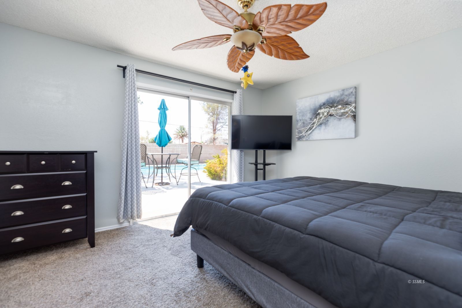 300 Mari Court Ridgecrest, CA 93555 - Photo 14 of 33 a bedroom with a bed and a chandelier