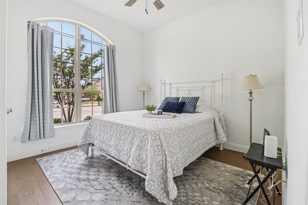 8277 Halifax The Colony, TX 75056 - Photo 22 of 37 a bedroom with a large bed and a window