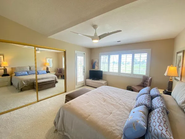 a bedroom with a large bed and a couch