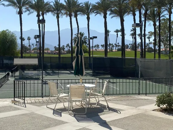 a swimming pool with outdoor seating and outdoor view