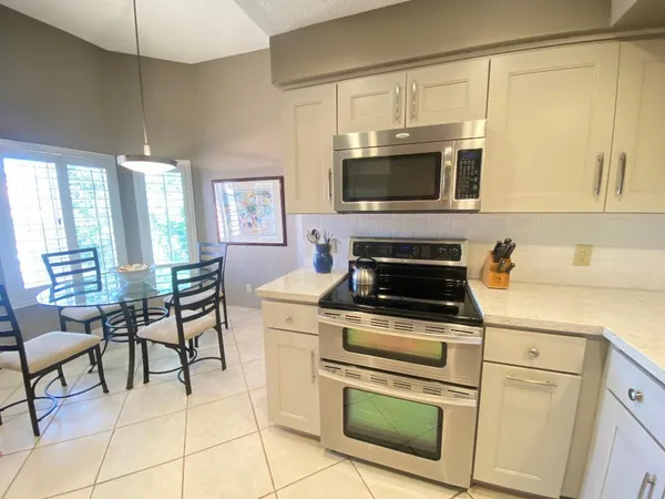 a kitchen with cabinets and appliances
