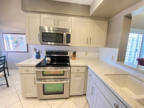 a kitchen with a stove microwave and sink