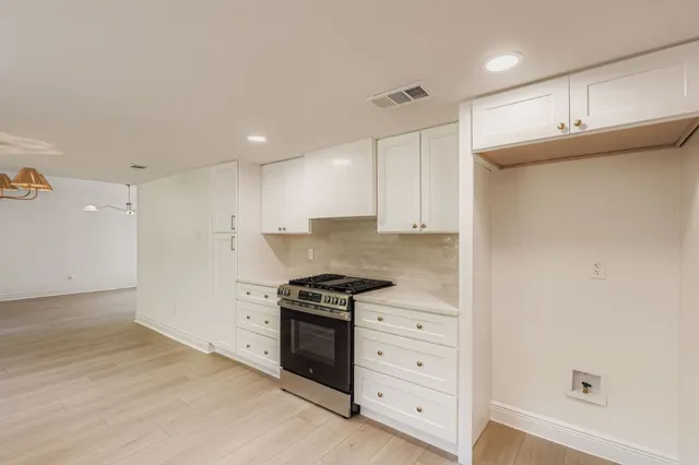 a kitchen with granite countertop a stove and a refrigerator