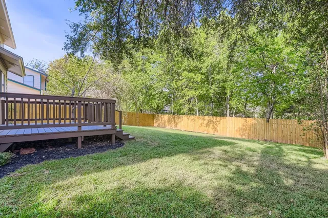 a view of backyard with deck and garden