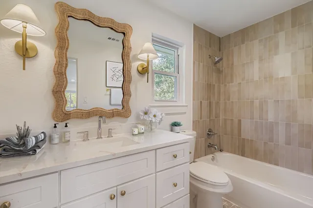 a bathroom with a double vanity sink mirror double and bathtub