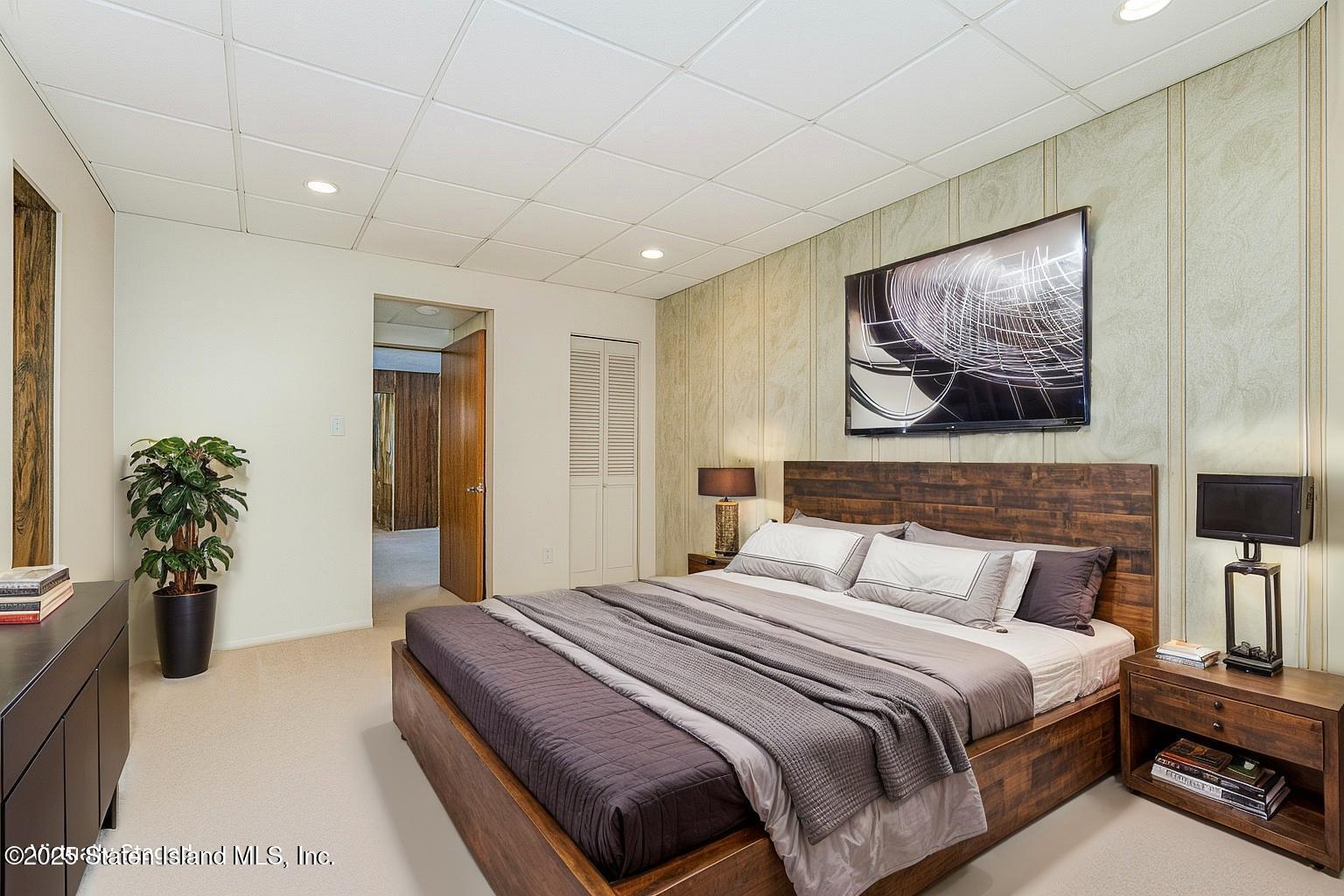 230 Fillmore Street Staten Island, NY 10301 - Photo 16 of 37 a bedroom with a bed and a painting on the wall