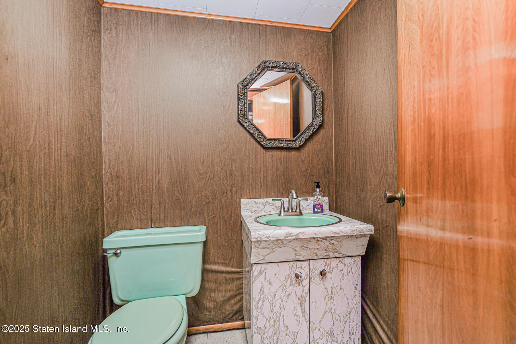 230 Fillmore Street Staten Island, NY 10301 - Photo 31 of 37 a bathroom with a toilet a sink and a mirror