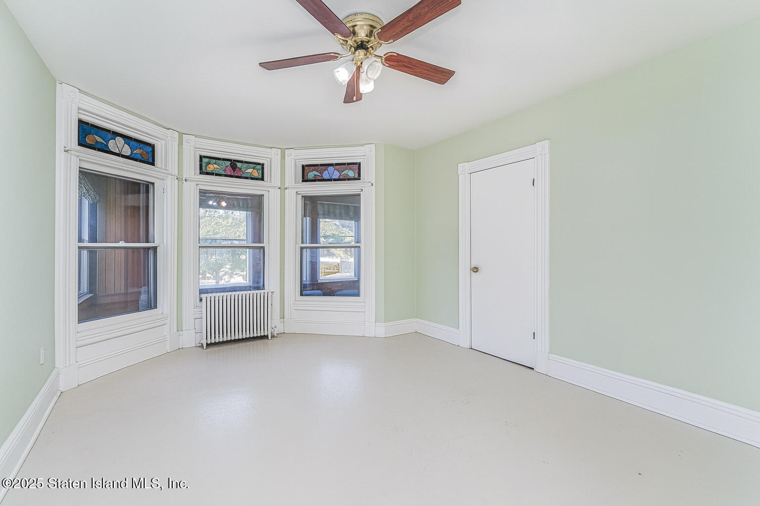 230 Fillmore Street Staten Island, NY 10301 - Photo 5 of 37 an empty room with windows and fan