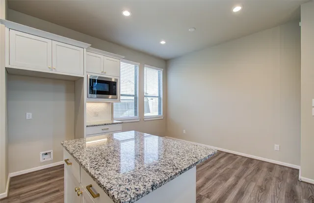 a kitchen with stainless steel appliances granite countertop a sink and a granite counter tops