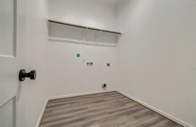 a view of a room with wooden floor