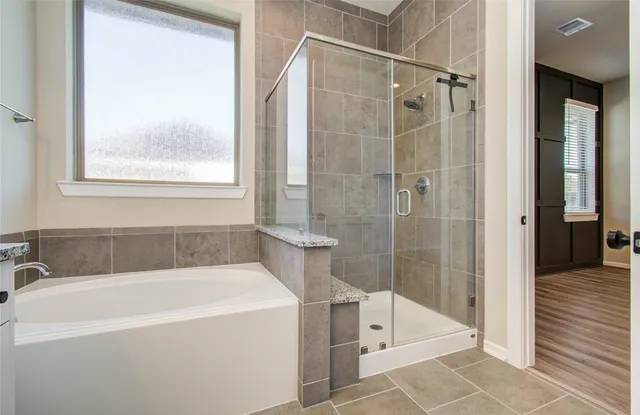 a white bath tub sitting next to a shower